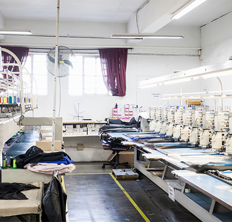Modern garment manufacturing unit with advanced stitching machines, representing HLK Industries’ expertise in sustainable apparel sourcing and production.